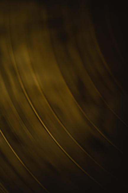 Detailed close-up of the grooves in a vinyl record, creating an abstract texture.