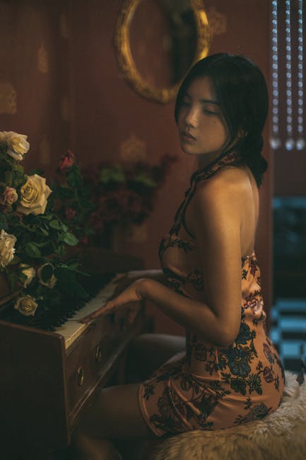 A portrait of an Asian woman playing the piano in a vintage setting with white and red roses.